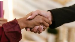 Close-up of two professionals shaking hands, symbolizing agreement and partnership.